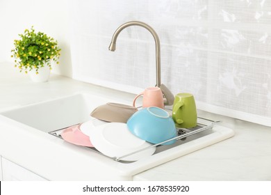 Drying Rack With Clean Dishes Over Sink In Kitchen