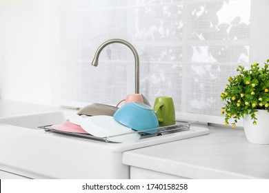 Drying Rack With Clean Dishes Over Sink In Kitchen