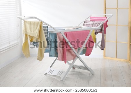 Drying rack with fresh clean laundry at home