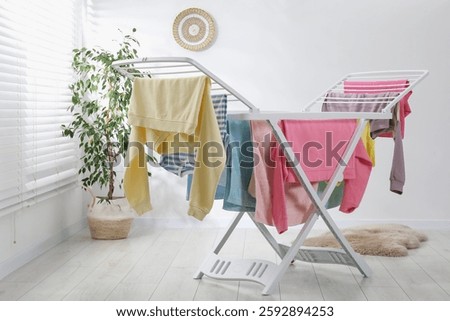 Drying rack with fresh clean laundry at home