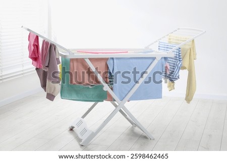 Drying rack with fresh clean laundry at home