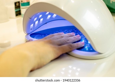 Drying Of The Varnish Applied To The Nails In A Professional Ultraviolet Machine.