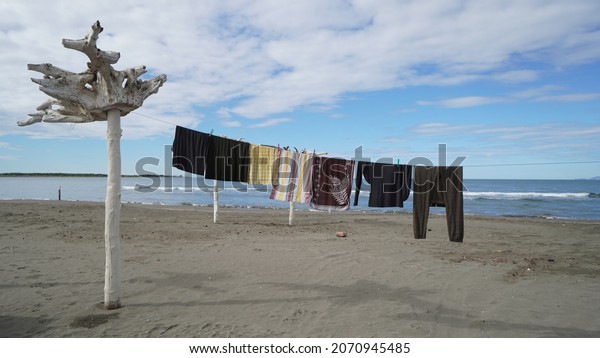 drying washed clothes on a clothe line at the\
beach, camping life,\
Albania