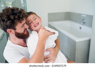 Drying you is the best time to tickle you. Cropped shot of a young handsome father drying his adorable little son after a bath in the bathroom at home.