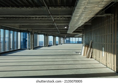 Drywall Awaiting Hanging On Empty Floor Of Large Highrise With Floor To Ceiling Windows On Clear Day