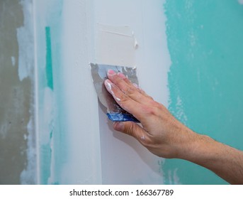 drywall hydrophobic plasterboard in green plastering seam with trowel
