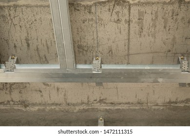 Drywall installation work in progress by construction workers at the construction site.