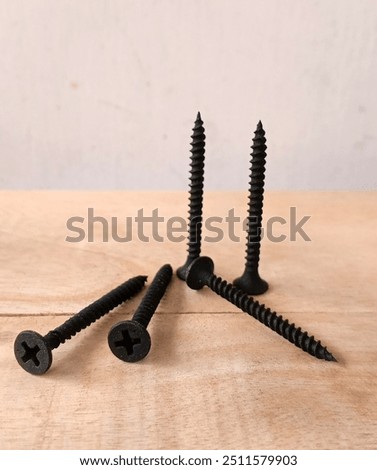 A drywall screw is a type of self-tapping screw specifically designed for fastening drywall to wooden or metal studs. They typically have a fine thread and a sharp point for easy penetration.