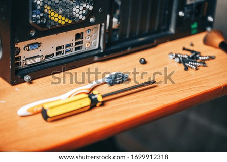 Dsassembling a computer with tools, screwdriver and brush for cleaning computer