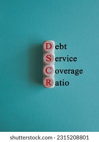 DSCR debt service coverage ratio symbol. Concept red words DSCR debt service coverage ratio on wooden cubes on beautiful blue background. Business DSCR debt service coverage ratio concept. Copy space. - Shutterstock ID 2315208801