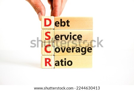 DSCR debt service coverage ratio symbol. Concept words DSCR debt service coverage ratio on wooden block on beautiful white background. Business DSCR debt service coverage ratio concept. Copy space.