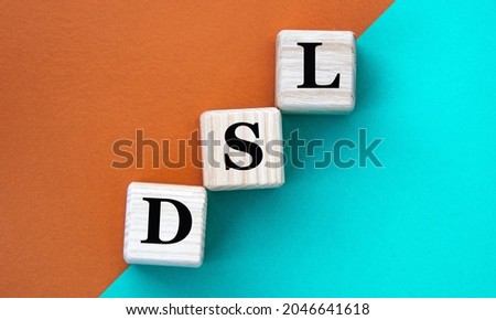 DSL (Domain Specific Language) - acronym on wooden cubes on a multi-colored background. Internet concept
