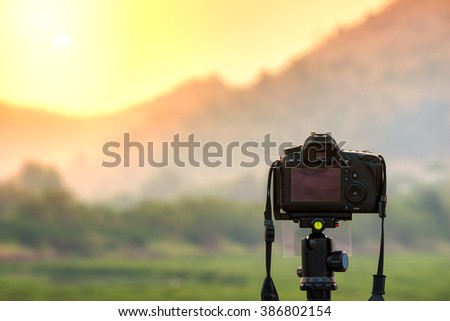 DSLR camera focus on sunrise landscape view.