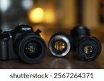 DSLR Camera with Interchangeable Lenses on Wooden Table in Soft Focus