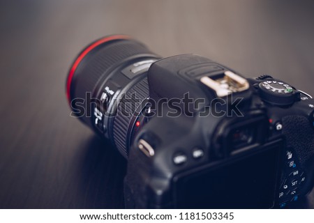 DSLR camera isolated on a black background. Black DSLR Camera isolated. Photo Camera or Video lens close-up on black background DSLR objective