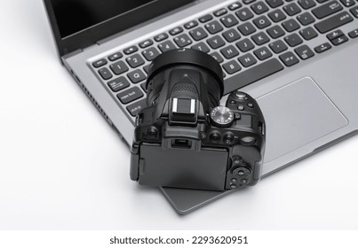 DSLR camera lying on an open laptop