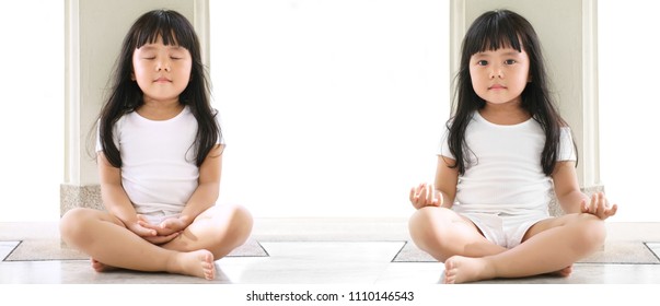 dual asian children cute or kid girl sit for meditation or yoga with open and close eye for peace or quiet and relax at temple or church and wear white dress with sunlight on white space background