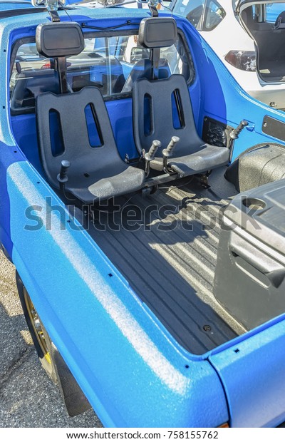 Dual seats in the back of\
a pickup truck for offroad use. Custom cars in Southern California\
summer 2017
