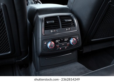 Dual-zone car climate control for rear passengers. Climate control dashboard display. Luxurious car air conditioner.