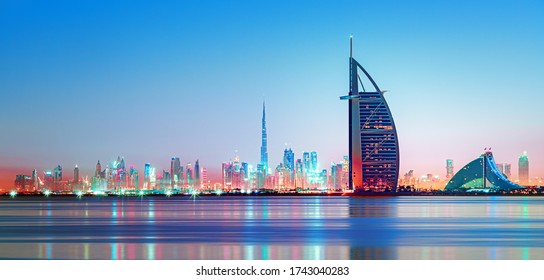 Dubai - amazing city center skyline and famous Jumeirah beach at sunset, United Arab Emirates