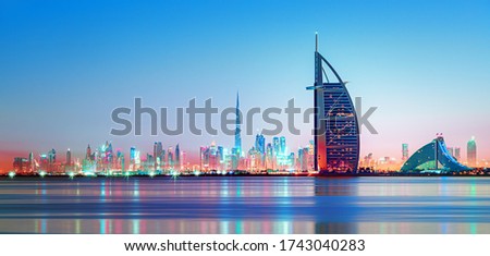 Dubai - amazing city center skyline and famous Jumeirah beach at sunset, United Arab Emirates