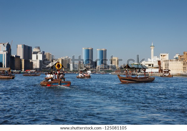 DUBAI CREEK, UAE - MAY 27 - Skyline view of Dubai\
Creek with traditional boat taxi activity. The creek is dividing\
the city into two main sections - Deira and Bur Dubai. Picture\
taken on May 27, 2010.