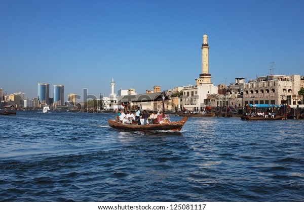 DUBAI CREEK, UAE - MAY 27 - Skyline view of Dubai\
Creek with traditional boat taxi activity. The creek is dividing\
the city into two main sections  Deira and Bur Dubai. Picture taken\
on May 27, 2010.