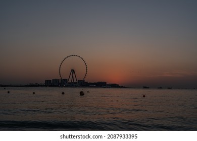 Dubai, December 2021 - sunset view of artificial island of Bluewaters with one of the biggest ferris wheel in the world "Ain Dubai" at JBR Beach 