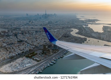 DUBAI - DECEMBER 27: Flydubai B737-800 is taking off from the Dubai International Airport with Burj Khalifa and downtown area visible in the background as seen on December 27, 2018.