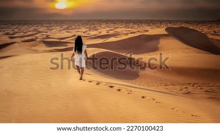 Dubai dessert sand dunes, Asian women on Dubai desert safari,United Arab Emirates, woman vacation in Dubai visit the sand dunes
