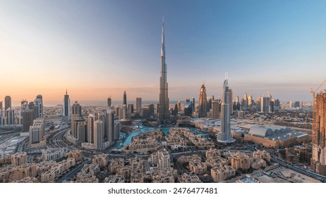 Dubai Downtown day to night transition timelapse with Burj Khalifa and other towers view from the top before new year celebration in Dubai, United Arab Emirates. Lights turning on. - Powered by Shutterstock