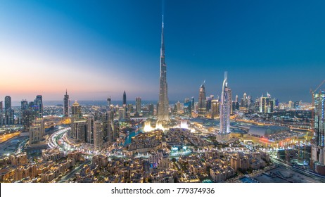 Dubai Downtown day to night transition timelapse with Burj Khalifa and other towers view from the top before new year celebration in Dubai, United Arab Emirates. Lights turning on.