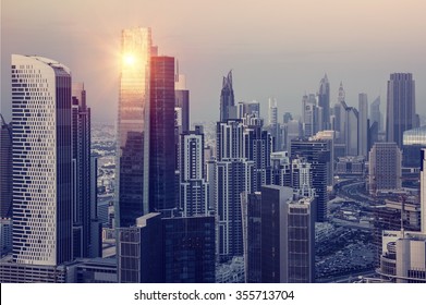 Dubai downtown in the evening, luxury modern buildings in bright yellow sunset light, futuristic cityscape of United Arab Emirates