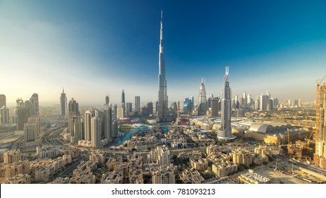 Dubai Downtown evening timelapse with Burj Khalifa and other towers paniramic view from the top in Dubai, United Arab Emirates. Shadows moves very fast. Traffic on circle road and fountains