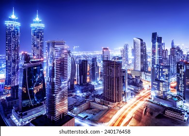 Dubai downtown night scene, UAE, beautiful modern buildings, bright glowing lights, luxurious travel and tourism 