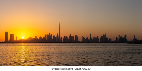 Dubai Downtown skyline panorama during sunset seen from Dubai Creek Harbour promenade. - Shutterstock ID 2126710250