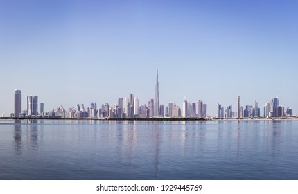 Dubai Downtown skyline panorama with reflections in Dubai Creek, cold colors, seen from Dubai Creek Harbour promenade. - Shutterstock ID 1929445769