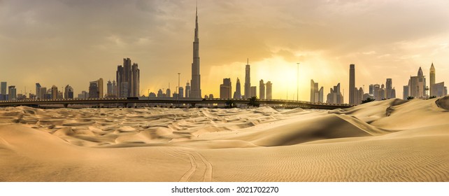 Dubai downtown skyline panorama at sunset with desert sand, United Arab Emirates