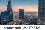Dubai downtown street before sunrise with busy traffic and skyscrapers around night to day. Modern road and urban buildings with mall aerial view with morning haze. Sheikh Mohammed bin Rashid Blvd