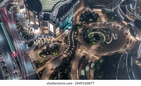 Dubai downtown street with busy traffic on circle and skyscrapers around night timelapse. Modern road and urban buildings with mall aerial view. Sheikh Mohammed bin Rashid Blvd - Powered by Shutterstock