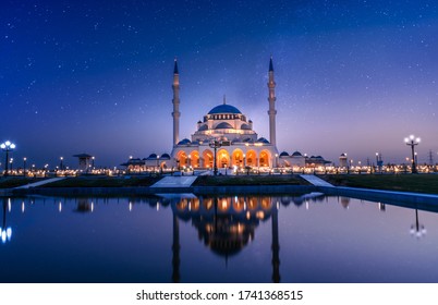 Dubai famous tourist spot, Sharjah Grand Mosque Night View, Best Places to visit in Dubai, Amazing architecture Design, Sharjah Travel and Tourism Image, Amazing mosque image night sky with stars  - Powered by Shutterstock