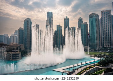 The Dubai Fountain, largest choreographed fountain system in the world. Fountain performing on a powerful beat matching the moody weather