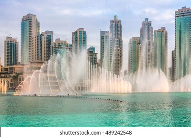 The Dubai Fountain, the world largest choreographed fountain on Burj Khalifa Lake, performs at sunset, to the beat of the selected music. On background, skyscrapers of Old Town Island near Dubai Mall.