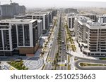 Dubai Hills Estate: Buildings and Hills Park with Roads, Under-Construction Buildings, and a Villa Community