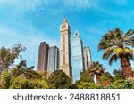 Dubai International Financial Centre DIFC Iconic The Tower clock amid modern Dubai skyscrapers on blue sky.