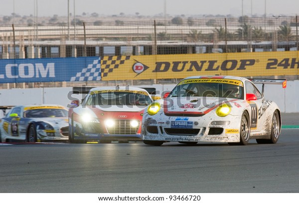 DUBAI - JANUARY 14: Porsche 997, Audi\
R8 and Mercedes SLS fighting for positions during the 2012 Dunlop\
24 Hour Race at Dubai Autodrome on January 14,\
2012.