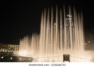 Dubai, March 12, 2022: Long exposure shot of famous dancing fountain show in front of Dubai mall. Large amount of water rocketing into the night sky.