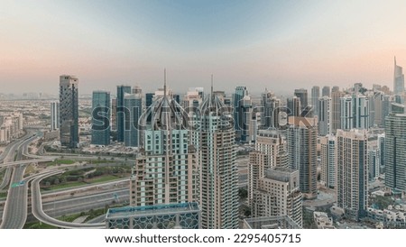 Dubai marina and JLT skyscrapers along Sheikh Zayed Road aerial  during sunset. Residential and office buildings from above.