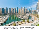 Dubai Marina Port, UAE, United Arab Emirates. Yachts are moored at city  in Dubai Marina. Cityscape skyline. Skyscrapers in Dubai.