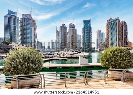 Dubai marina with yachts in UAE. High-rise residential buildings, business skyscrapers